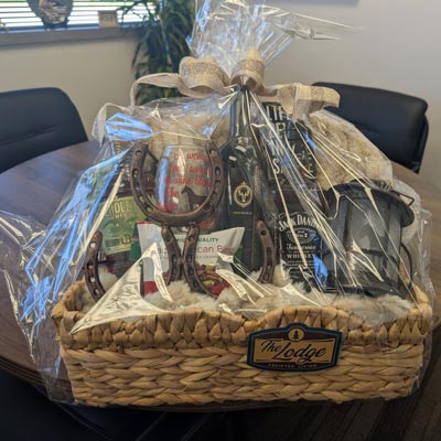 Jack Daniels, Pendelton Whiskey and Loose Moose Zin as well as a horseshoe wine rack, a blanket and more!